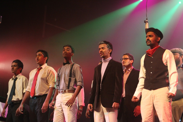 Eine Tagungsatmosphäre mit Sitzplätzen und einer Bühne, auf der eine Diskussion zwischen Medienpersonal und Eigentümern stattfindet, mit einem großen Banner und einer Wand im Hintergrund.