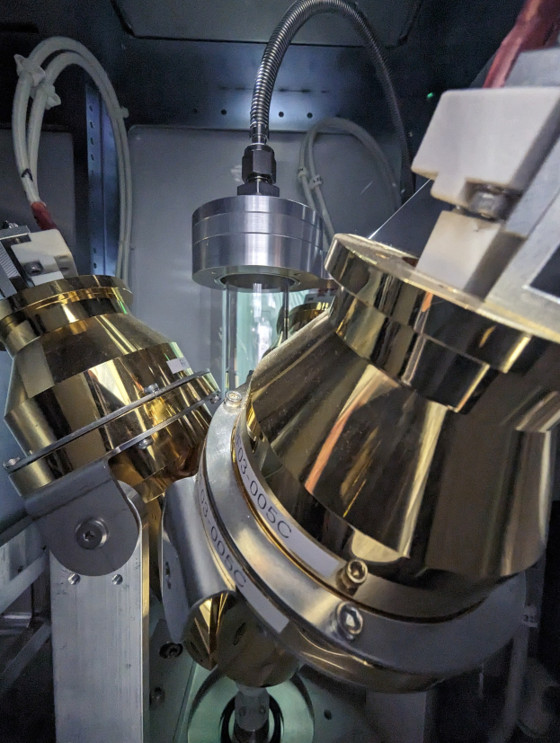 CNC-Fräsmaschine bei der Bearbeitung eines Metallobjekts in einer Fabrikumgebung, mit Werkzeugen und Komponenten verbunden.