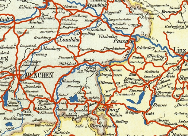 Ein detaillierter Stadtplan von München, Deutschland, der Straßen, Parks, Sehenswürdigkeiten und umliegende Gebiete in Blau-, Grün- und Gelbtönen zeigt.